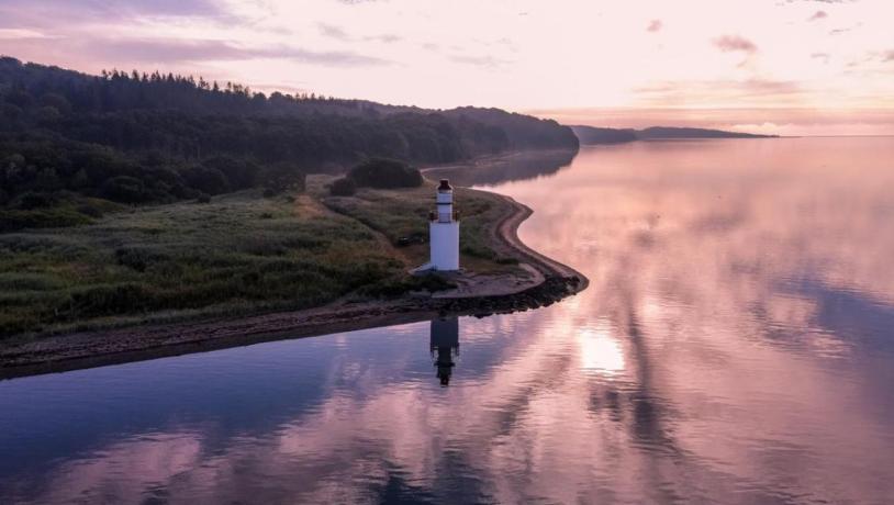 View of the coastal line and lighthouse in the area of Hotel Vejlefjord in the coastal land