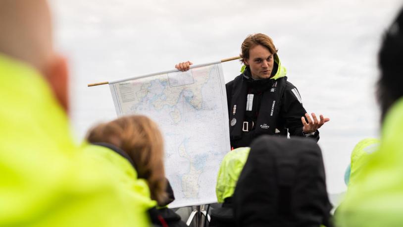 The World's Tiniest Cruise in The Coastal Land in Denmark Tour Guide holds a map