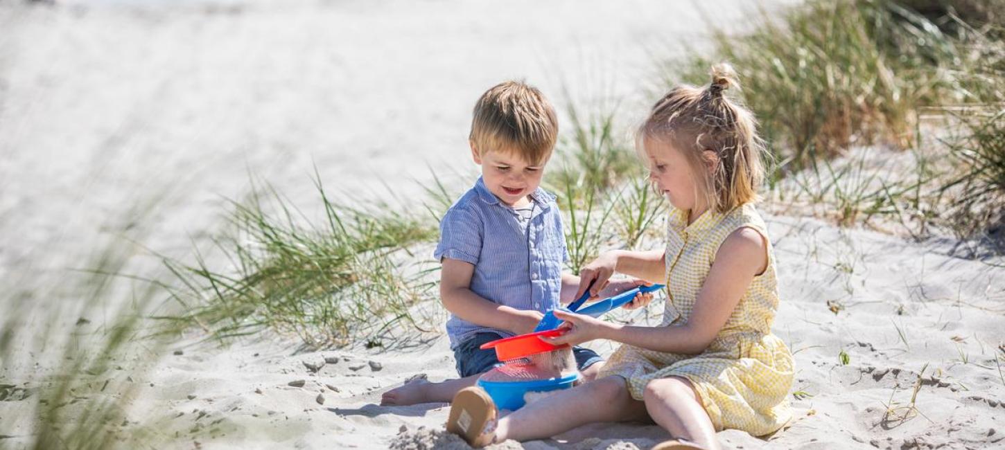 Kids are playing on the beach at Saksild